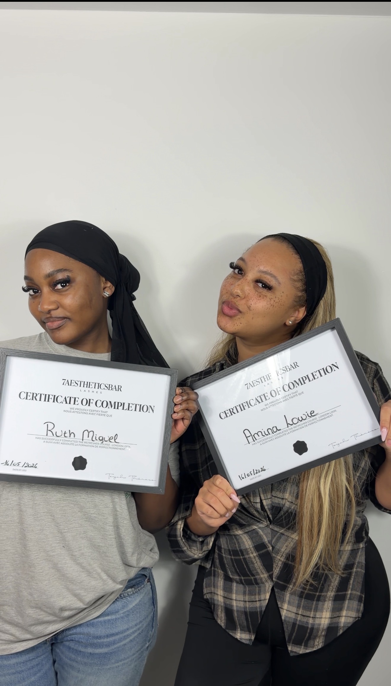 Two 7AESTHETICSBAR students holding their certificates of completion