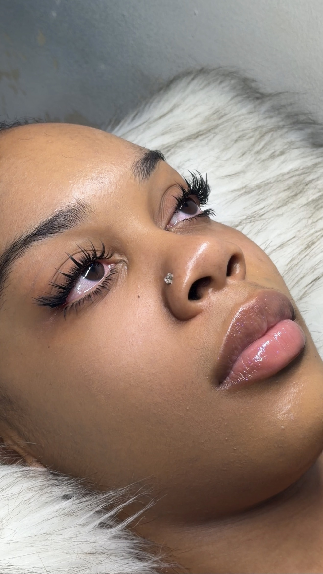 Client with a fully designed custom lash set and chrome nails